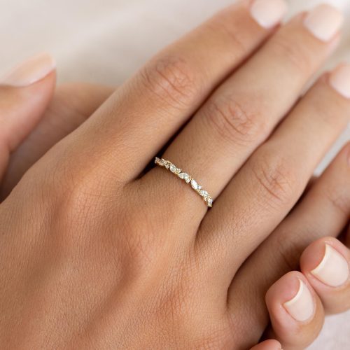 Marquise and round diamond ring in 14k yellow gold band on hand